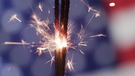 video of close up of sparklers with copy space over flag of usa