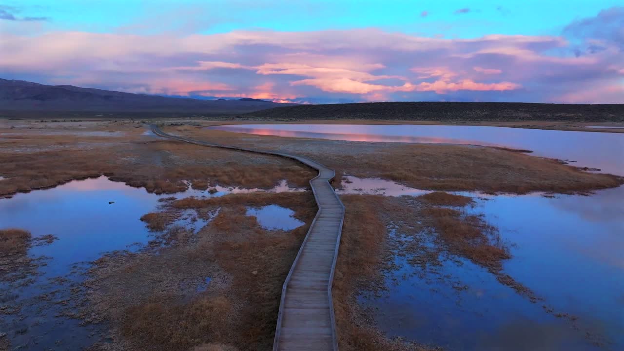 Boardwalk Hilltop Wild Willy's Hot Springs Mammoth Lakes California aerial drone winter vibrant sunset clouds Benton Crossing Lake Crowley Long Valley Caldera valley birds flying forward pan up motion
