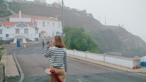 pretty girl exploring city on vacation vertically. tourist walking european town