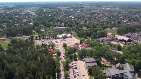 A-stunning-aerial-view-of-Sigulda-city,-highlighting-its-integration-with-lush-green-spaces-and-natural-landscapes