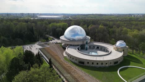 Stars-observatory-during-a-beautiful-summer-day,-surrounded-by-lush-greenery,-grass,-and-trees-under-a-clear-blue-sky