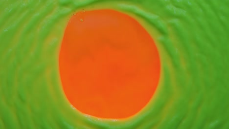 wind blows into the center of the fluorescent paint and blows it off in the shape of a circle. top view. color abstract background.