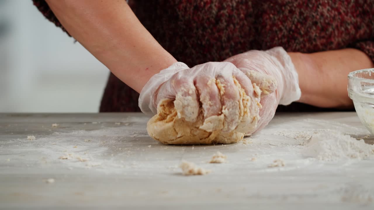 Close-Up of Hands Kneading Dough on a Floured Kitchen Countertop