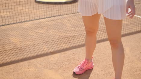 beautiful tennis girl practicing serve on outdoor court