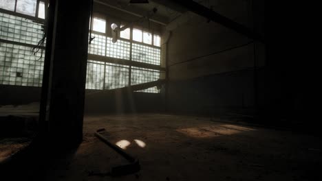 abandoned industrial interior in dark colors on a sunny day and with the sun's rays