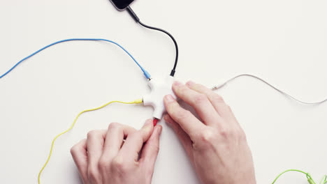 Top-view-hands-connecting-data-cables-global-sharing-network-concept-desk-from-above---Red-Epic-Dragon