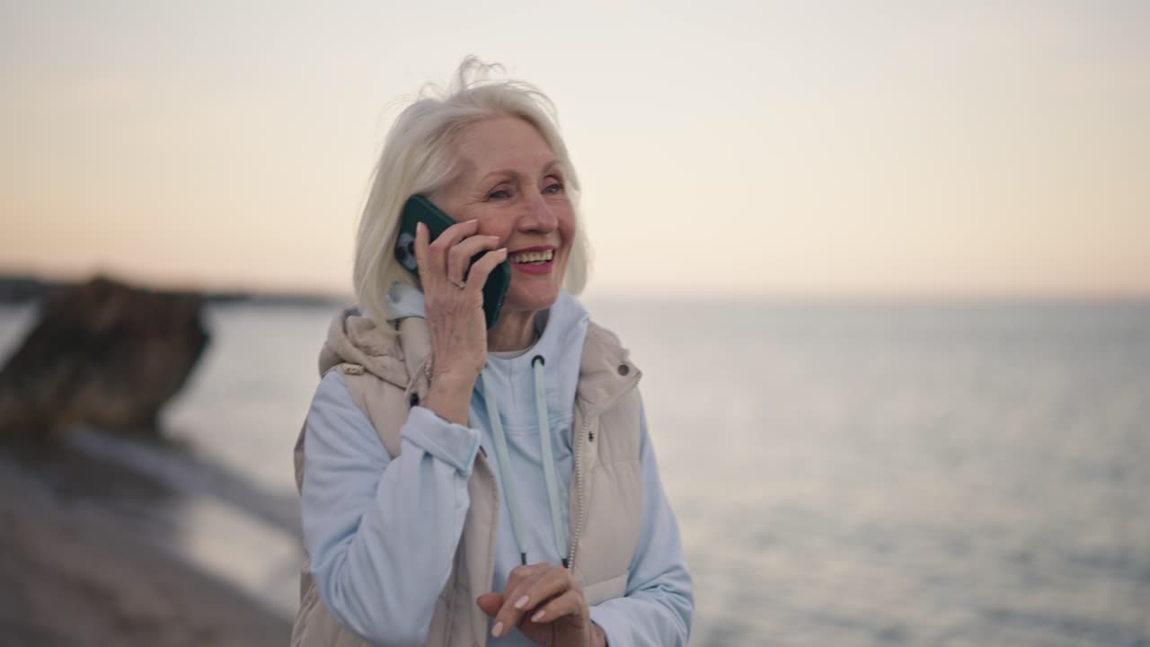 Senior Woman on Phone Call at the Beach