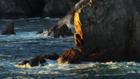 close-up of waves breaking at the white cliffs of ashleam during sunset