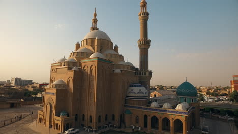 view of a large mosque with domes and beacons