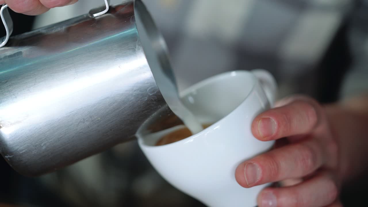 Barista drawing the heart on the coffee. Concept of services and beverages.