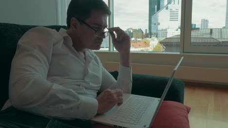 young businessman working with laptop at home