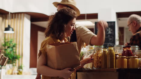 woman grocery shopping helped by clerk