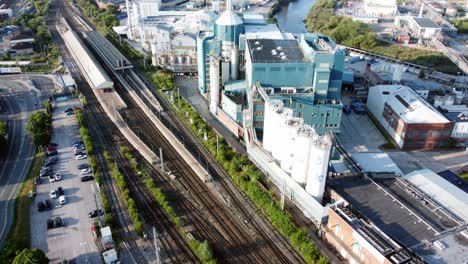 industrial chemical manufacturing factory next to warrington bank quay train tracks aerial view top down tilt up