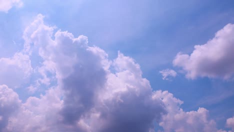 timelapse: sun beams shining through moving dramatic white clouds