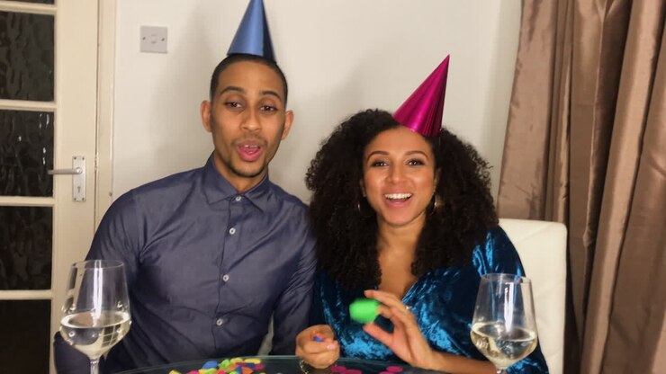 Young Adult Couple On Video Call Counting Down to Midnight and Celebrating Turn of the New Year