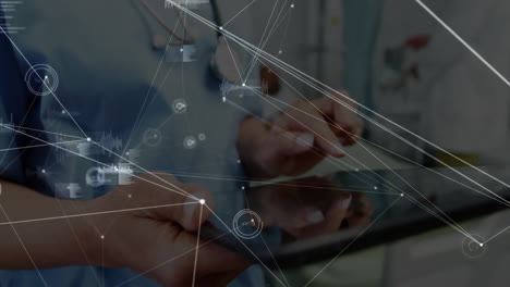 healthcare professionals tapping tablet in clinic, displaying digital network lines, chart graphics