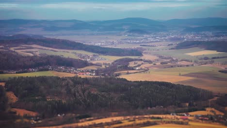 A-patchwork-of-fields,-forests,-and-villages-of-Southern-Bohemia-in-aerial-video