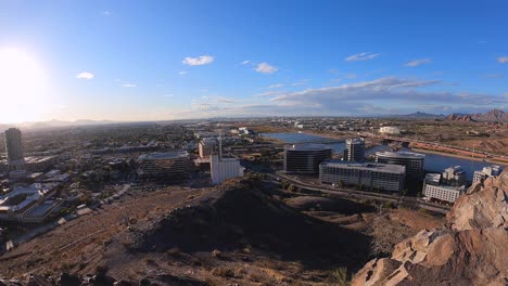 Time-lapse-from-the-top-of-A-mountain-Tempe-waterfront-glass-skyscrapers,-bridges,-and-freeway-traffic-looking-west