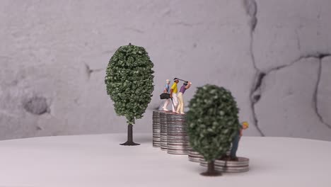 miniatures and piles of coins with business concepts.