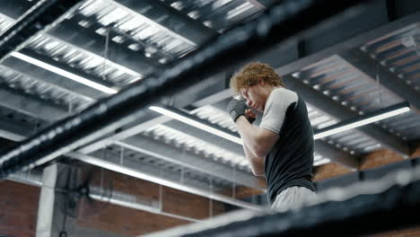 energetic fighter warming up in fitness center