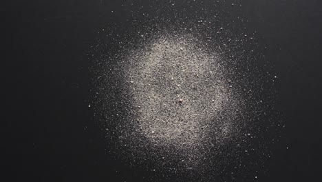 video of close up of sand grains and copy space on black background