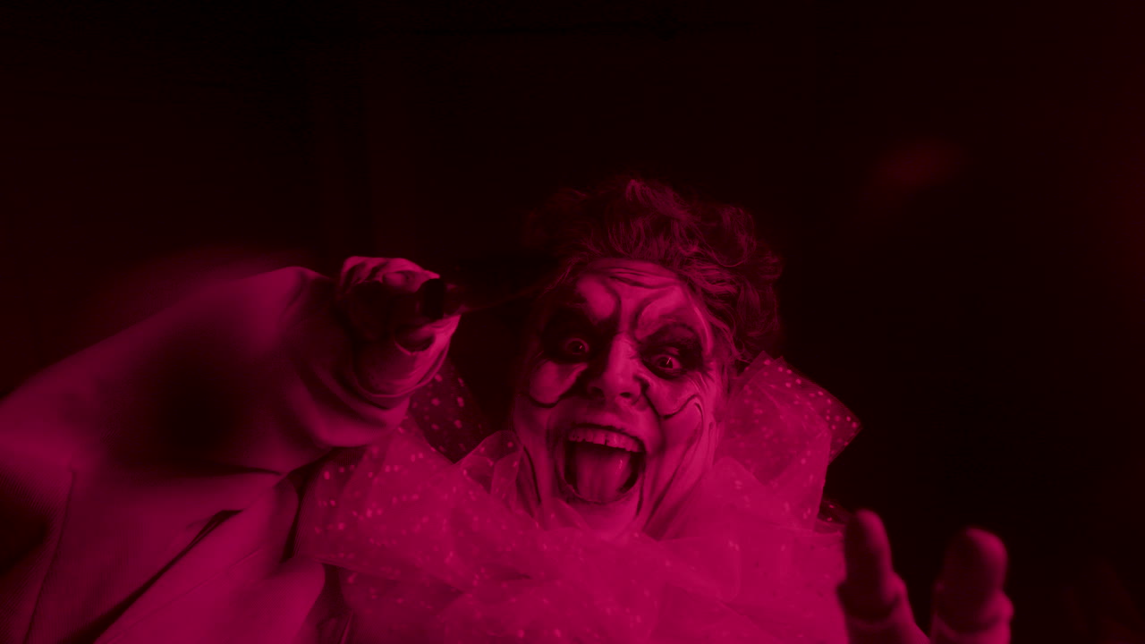 Clown holding bloody knife