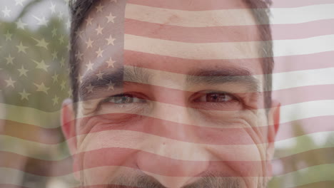 animation of american flag over portrait close up of happy caucasian man smiling in sunny garden