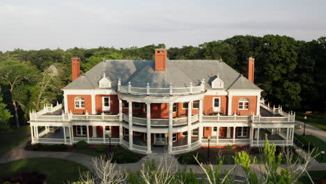 aerial view flying backwards reveals a panoramic view over roger williams park casino