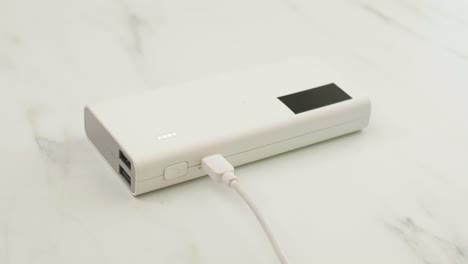 Man-connect-cable-for-charging-power-bank