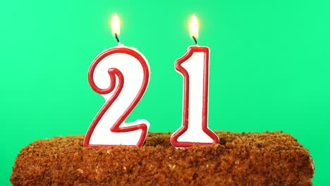 cake with the number 21 lighted candle. chroma key. green screen. isolated