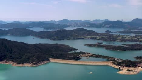 aerial dolly in of high island reservoir verdant islets and hills surrounded by turquoise water, san kung peninsula in hong kong, china