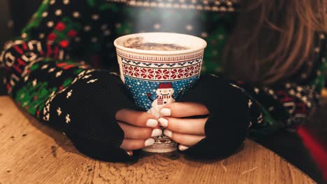 beautiful girl holding steaming christmas mug with cold hands