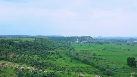 aerial drone view of a rural village of india covered with lush green jungle in gwalior madhya pradesh india