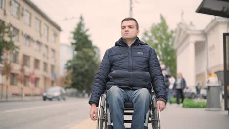 person with a physical disability waiting for city transport with an accessible ramp