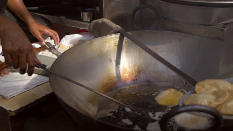 street vendor frying a puri