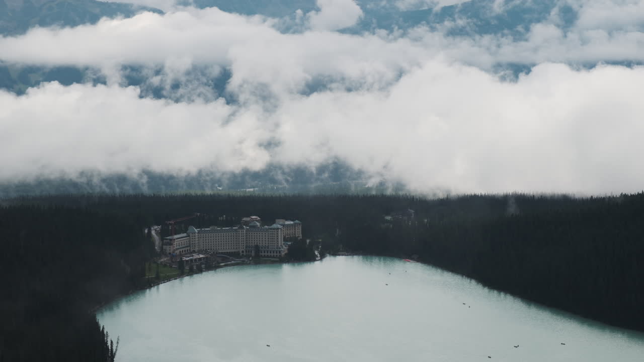 Overlooking the iconic Fairmont Château Lake Louise framed by a dramatic cloudscape