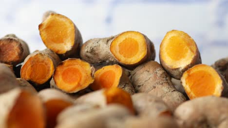 detail shot of turmeric root in bowl on table