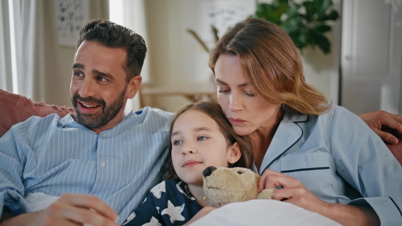 Funny family watching movie having fun at interior closeup. Girl eating popcorn