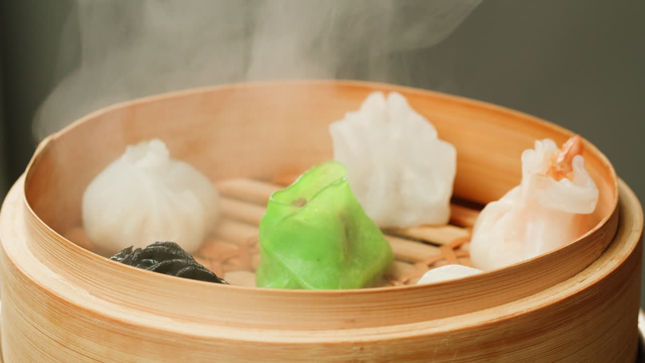 Hand Lifts Lid from Bamboo Steamer Revealing Hot Dim Sum