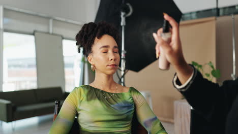 woman getting makeup applied in a studio