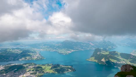 time lapse of lake lucerne in switzerland with clouds moving over blue water, green alps