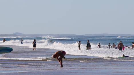 surfers and beachgoers enjoying the ocean waves