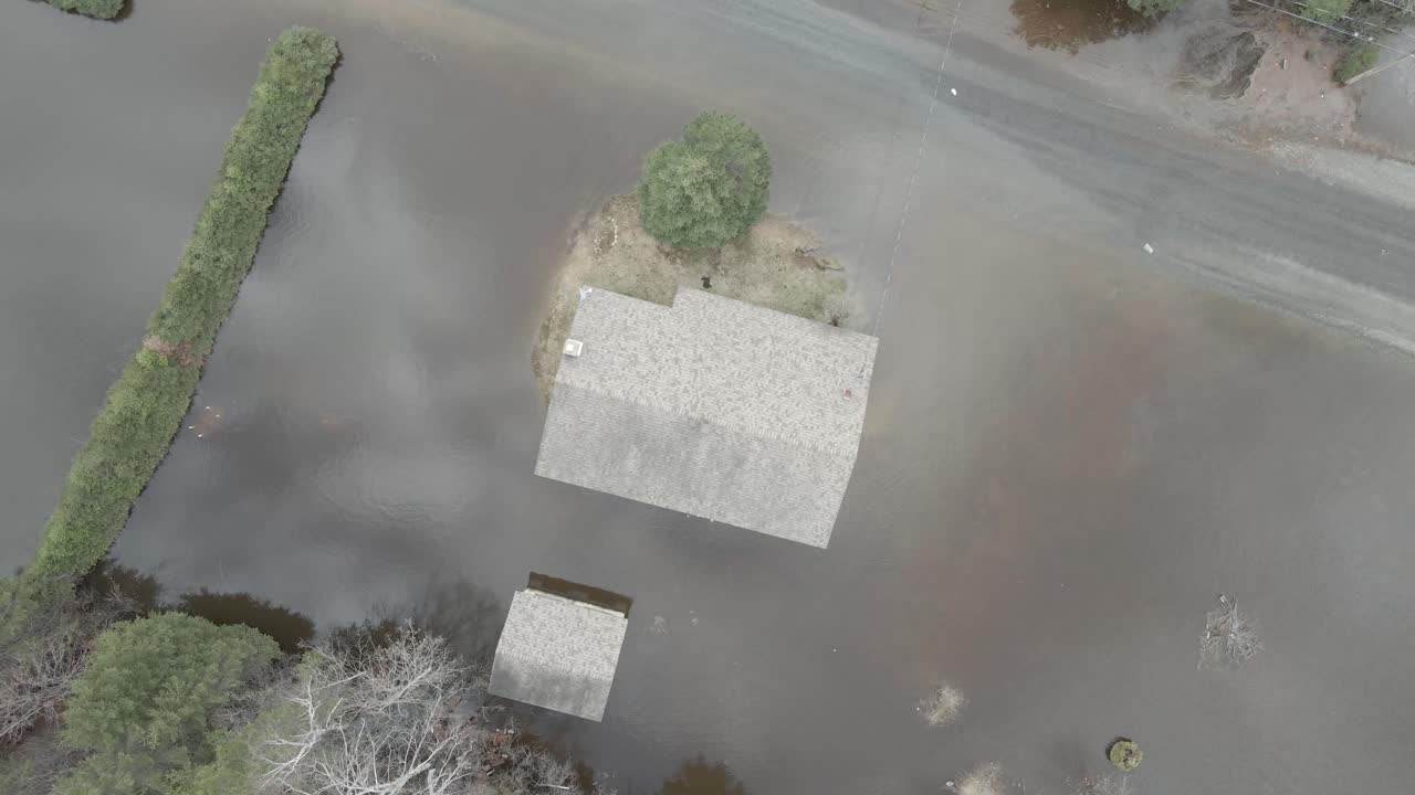 Aerial shot of flooded homes, trailers, and streets in Quebec neighborhood.