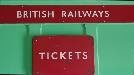 Red-retro-British-Railways-tickets-sign-close-up-green-background