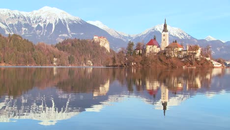 a church stands on an island at lake bled slovenia