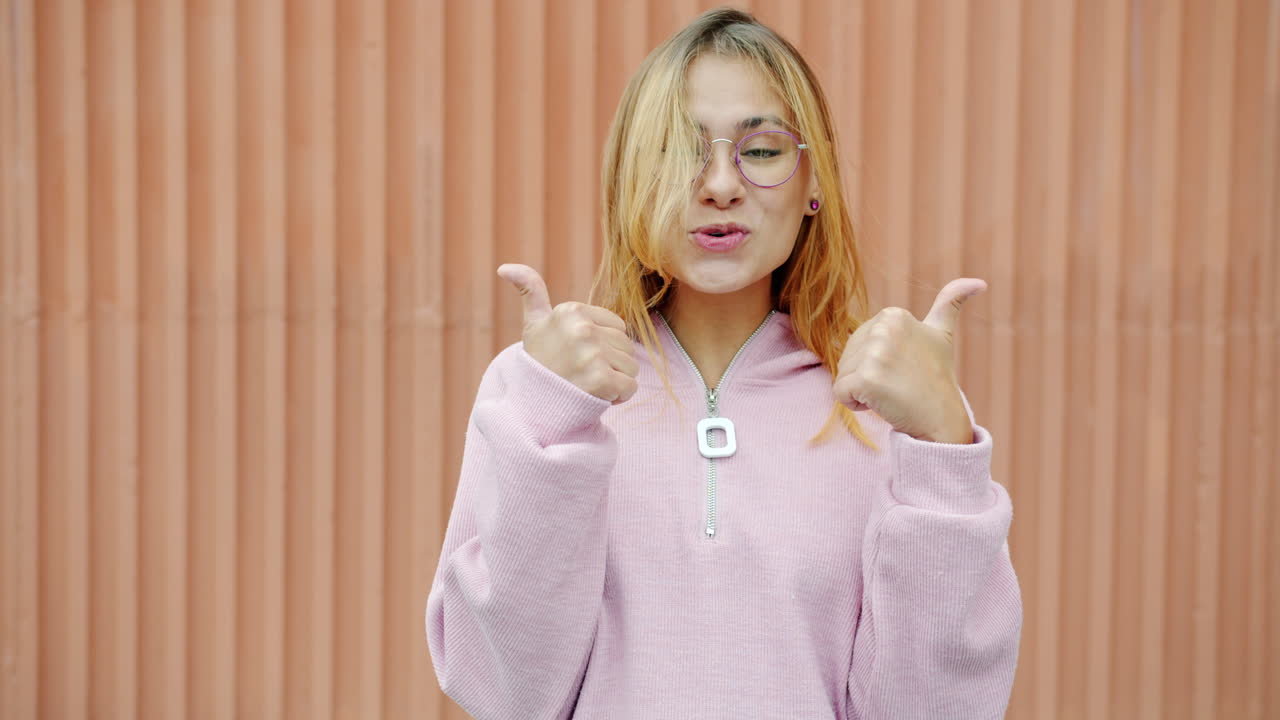 Young Woman with Glasses and Pink Sweatshirt