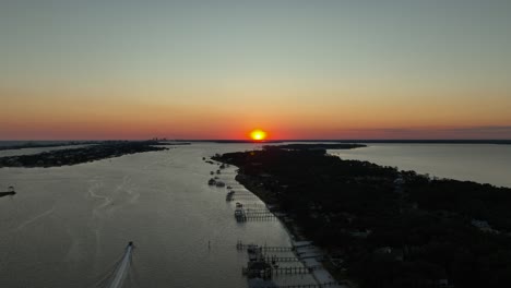 aerial reverse view of sunset over alabama near inlet waterway and wolf bay