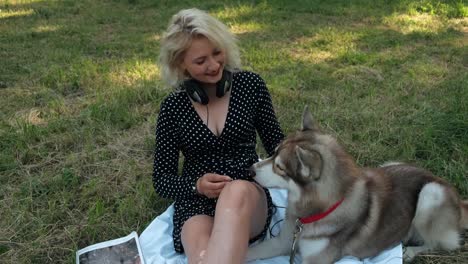 the girl in the park feeds the dog