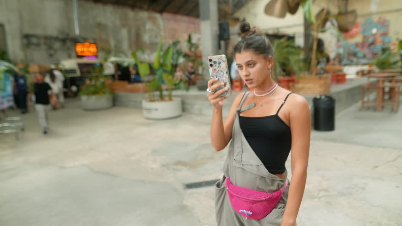 A woman indoors using her phone