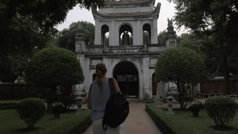 tourist shooting temple of literature main gate hanoi vietnam